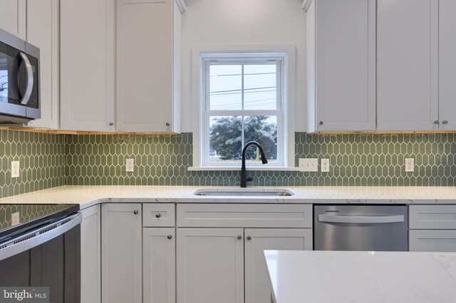 520 Woodcrest Ave, Lititz, PA 17543 - kitchen with stainless steel appliances, decorative backsplash, white cabinets, and a sink
