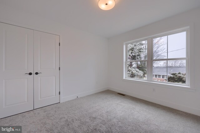 520 Woodcrest Ave, Lititz, PA 17543 - unfurnished bedroom with a closet, multiple windows, carpet floors, and baseboards
