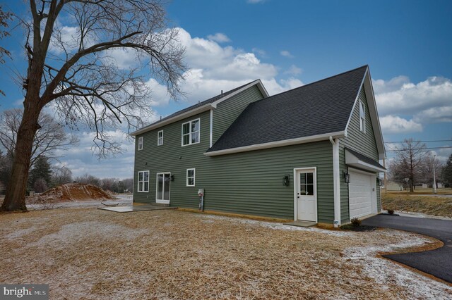 520 Woodcrest Ave, Lititz, PA 17543 - back of house with aphalt driveway, a shingled roof, and an attached garage