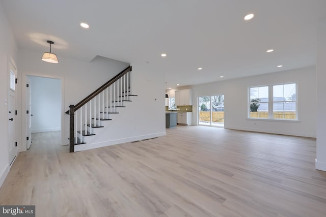 520 Woodcrest Ave, Lititz, PA 17543 - unfurnished living room featuring light wood finished floors, stairs, recessed lighting, and baseboards
