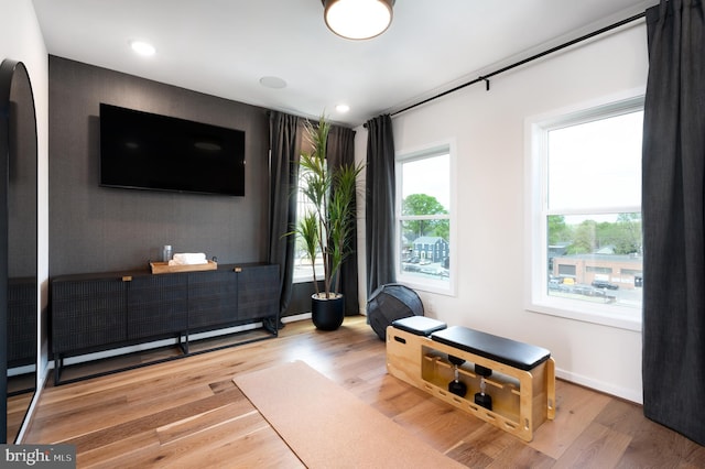 living area featuring wood finished floors, recessed lighting, and baseboards