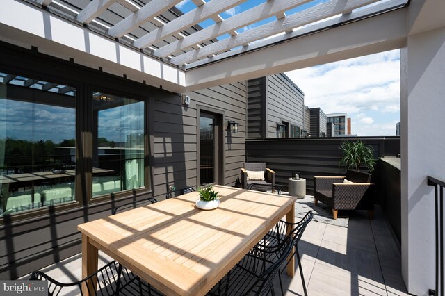 view of patio with a pergola and outdoor dining area