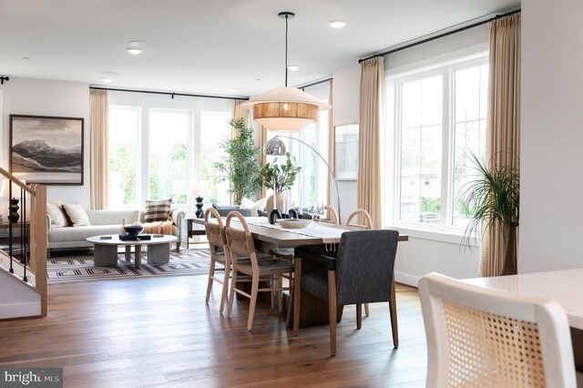 dining room with recessed lighting, wood finished floors, and a healthy amount of sunlight