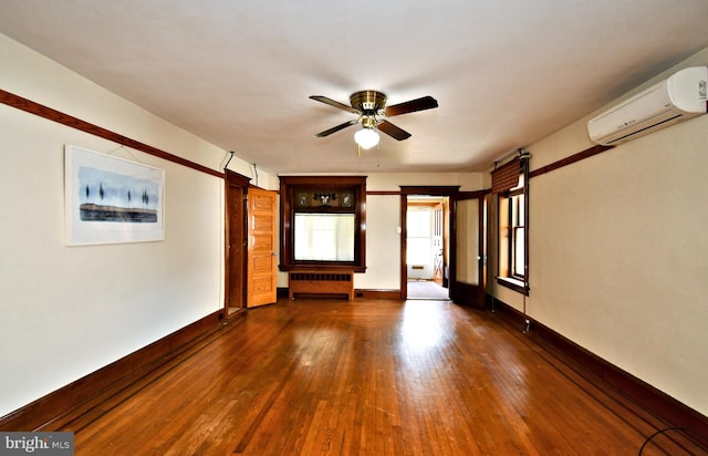 133 Main St, East Greenville, PA 18041 - empty room featuring a wall unit AC, ceiling fan, dark wood finished floors, and baseboards
