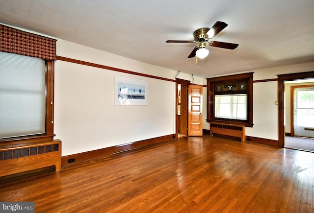 133 Main St, East Greenville, PA 18041 - unfurnished living room featuring radiator, hardwood / wood-style floors, baseboards, and ceiling fan