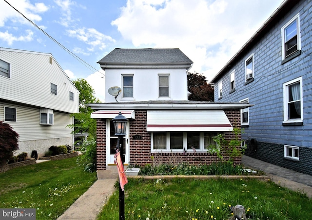 133 Main St, East Greenville, PA 18041 - view of front facade featuring brick siding, a front yard, and stucco siding