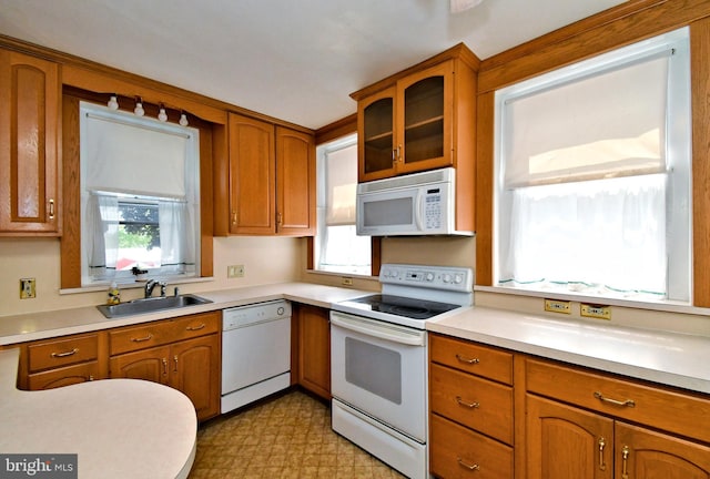 133 Main St, East Greenville, PA 18041 - kitchen featuring white appliances, a sink, healthy amount of natural light, and brown cabinets
