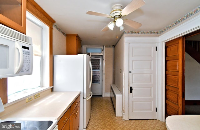 133 Main St, East Greenville, PA 18041 - kitchen featuring white appliances, light flooring, brown cabinets, and a ceiling fan