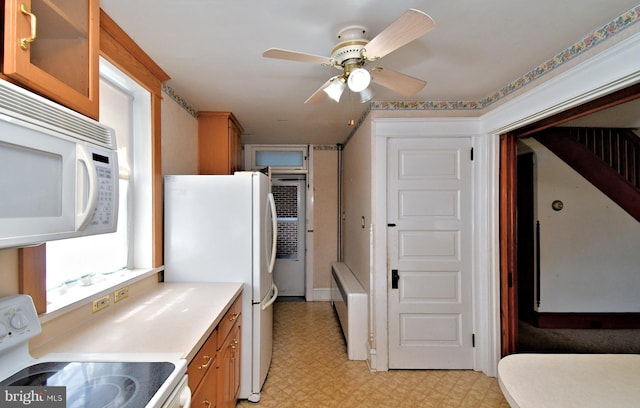133 Main St, East Greenville, PA 18041 - kitchen featuring white appliances, light flooring, ceiling fan, light countertops, and glass insert cabinets