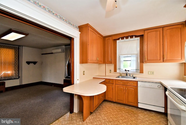 133 Main St, East Greenville, PA 18041 - kitchen featuring white appliances, a sink, an AC wall unit, a peninsula, and brown cabinetry