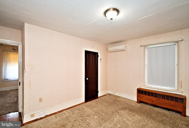 133 Main St, East Greenville, PA 18041 - carpeted spare room with radiator heating unit, an AC wall unit, and baseboards