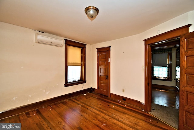 133 Main St, East Greenville, PA 18041 - empty room featuring an AC wall unit, dark wood finished floors, and baseboards