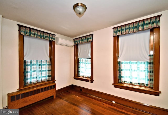 133 Main St, East Greenville, PA 18041 - empty room with radiator heating unit, a wall mounted AC, dark wood-type flooring, and baseboards