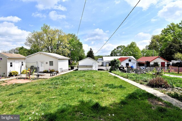 133 Main St, East Greenville, PA 18041 - view of grassy yard featuring a garage and a patio area