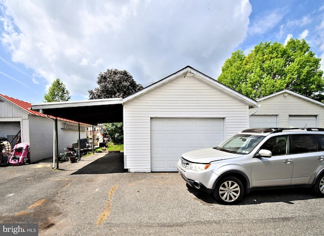 133 Main St, East Greenville, PA 18041 - view of front of property with an outbuilding, asphalt driveway, and a garage
