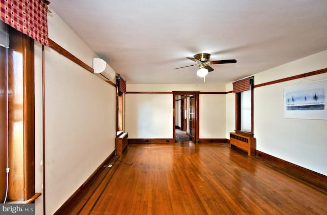 133 Main St, East Greenville, PA 18041 - spare room with a wall mounted air conditioner, radiator, wood finished floors, a ceiling fan, and baseboards