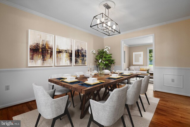 dining area featuring an inviting chandelier, ornamental molding, wainscoting, and wood finished floors