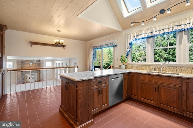 kitchen featuring plenty of natural light, tile patterned flooring, stainless steel dishwasher, and brown cabinetry