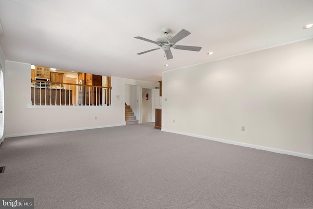unfurnished living room featuring ceiling fan, stairway, baseboards, carpet flooring, and recessed lighting