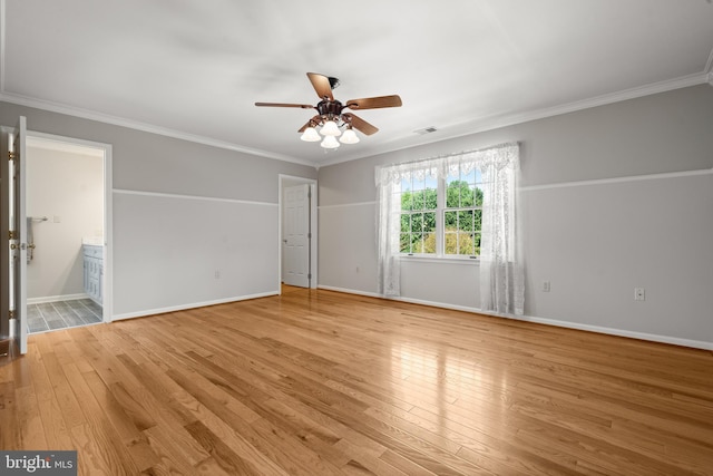 unfurnished room with ceiling fan, visible vents, baseboards, light wood finished floors, and ornamental molding