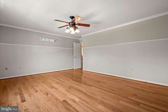 unfurnished room featuring baseboards, ceiling fan, ornamental molding, and wood finished floors