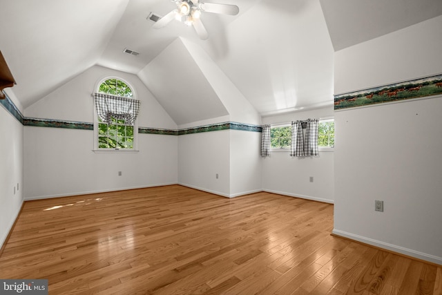 bonus room featuring a wealth of natural light, lofted ceiling, ceiling fan, and visible vents