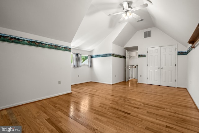 additional living space with visible vents, a ceiling fan, lofted ceiling, and light wood-type flooring