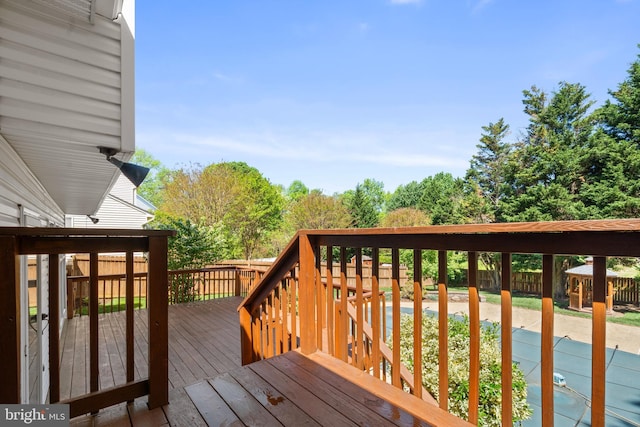 wooden deck featuring a fenced backyard