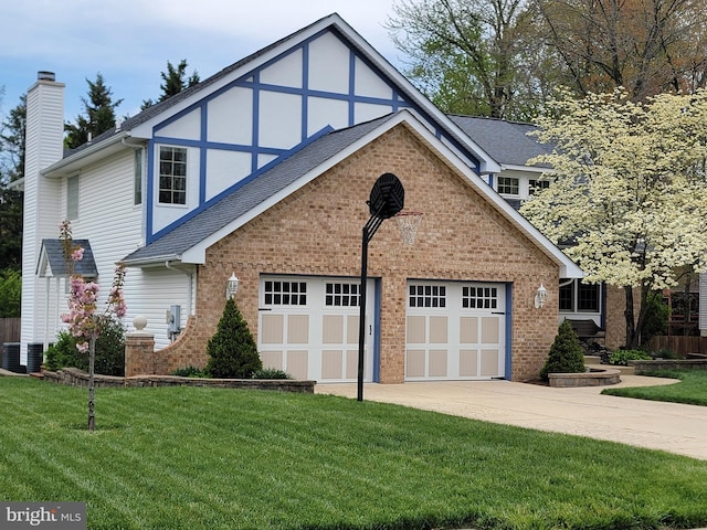 view of front facade with a chimney, driveway, a front lawn, and brick siding