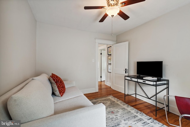 living area with wood finished floors, ceiling fan, and baseboards