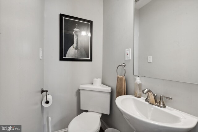 half bath featuring a sink and toilet