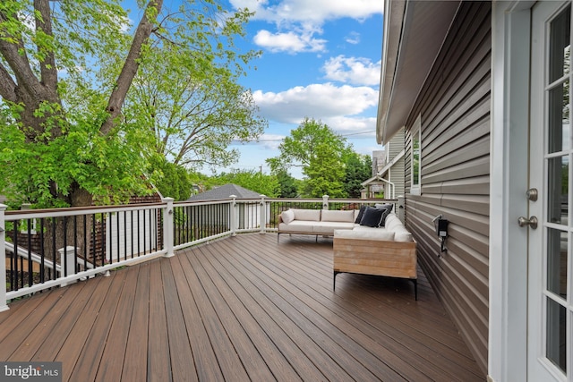 wooden terrace featuring outdoor lounge area