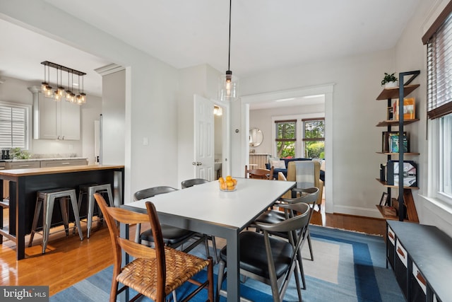 dining space featuring wood finished floors and baseboards