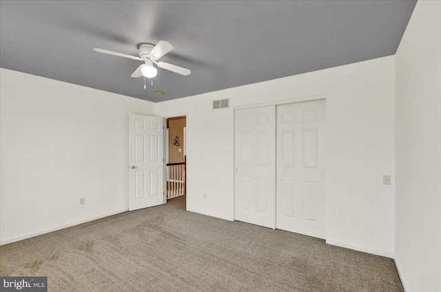 unfurnished bedroom featuring a closet, carpet flooring, baseboards, and visible vents