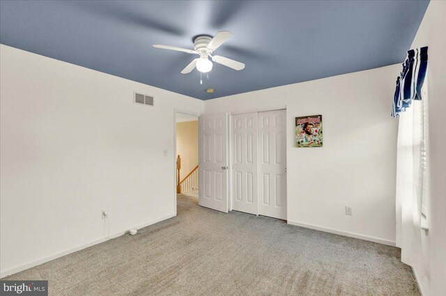 unfurnished bedroom featuring carpet flooring, a closet, visible vents, and baseboards