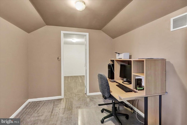 office space featuring baseboards, visible vents, lofted ceiling, and carpet flooring