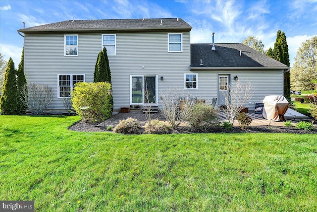 back of property with a patio and a yard