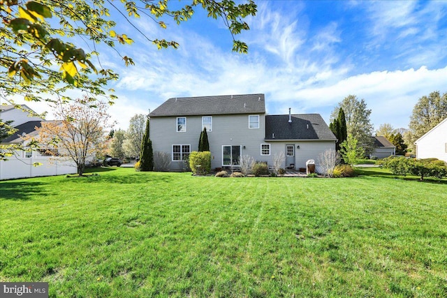 back of property featuring a lawn