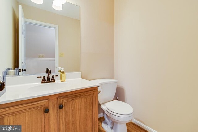 10995 Alcorn Ln, Waldorf, MD 20603 - half bath featuring vanity, toilet, wood finished floors, and baseboards