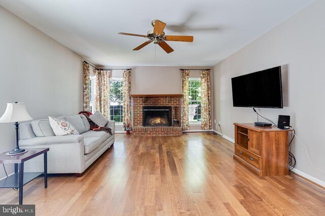 10995 Alcorn Ln, Waldorf, MD 20603 - living room featuring ceiling fan, light wood-style floors, a fireplace, and baseboards