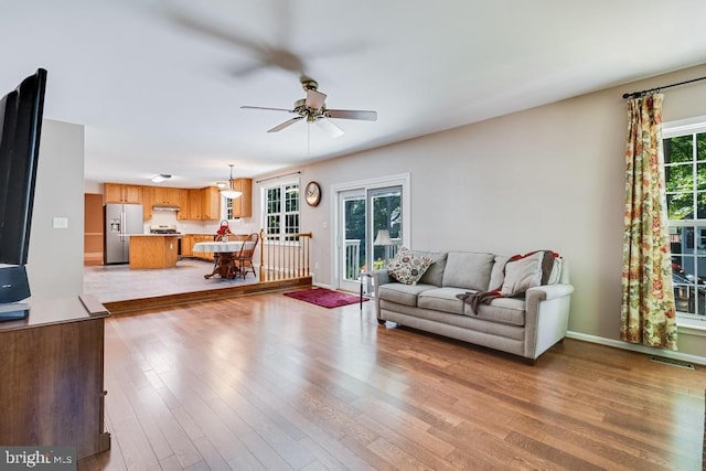 10995 Alcorn Ln, Waldorf, MD 20603 - living room featuring a ceiling fan, light wood-style floors, and baseboards