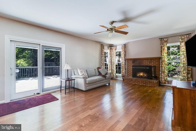 10995 Alcorn Ln, Waldorf, MD 20603 - living area with a ceiling fan, wood finished floors, and a brick fireplace