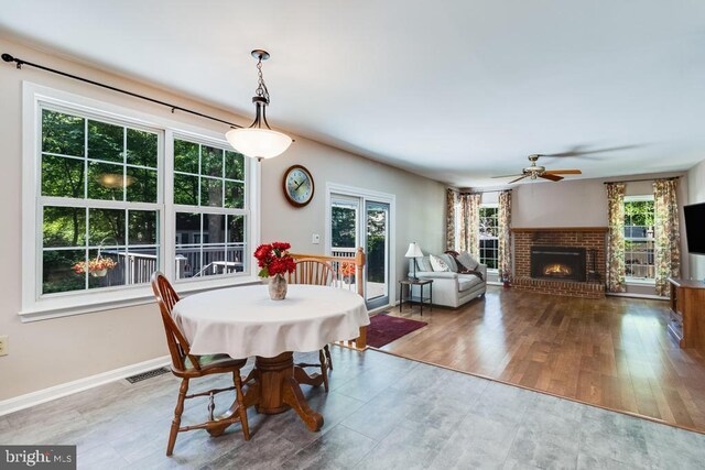 10995 Alcorn Ln, Waldorf, MD 20603 - dining space with a brick fireplace, a ceiling fan, wood finished floors, and baseboards