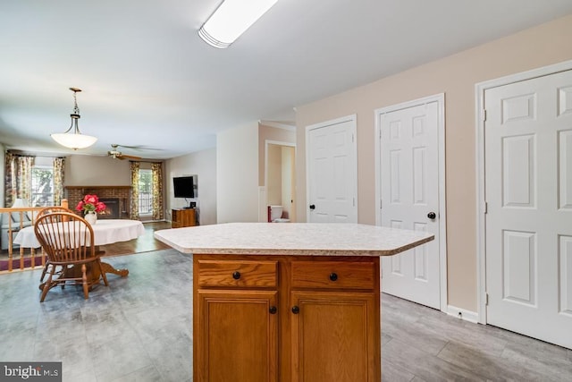 10995 Alcorn Ln, Waldorf, MD 20603 - kitchen with light countertops, open floor plan, a fireplace, and pendant lighting