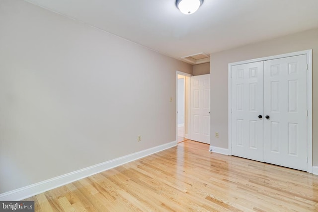 10995 Alcorn Ln, Waldorf, MD 20603 - unfurnished bedroom featuring attic access, light wood finished floors, baseboards, and a closet