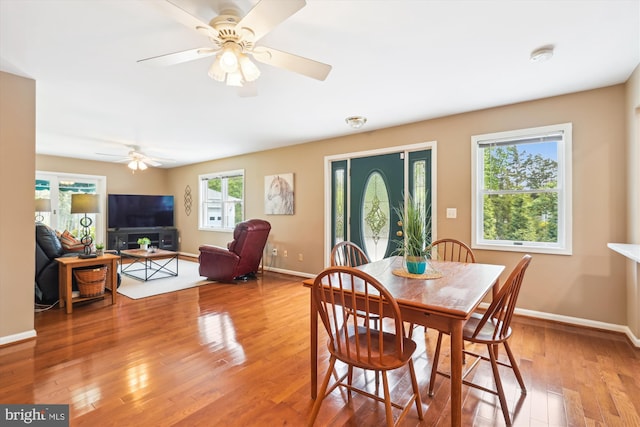 dining area with baseboards, light wood finished floors, and ceiling fan