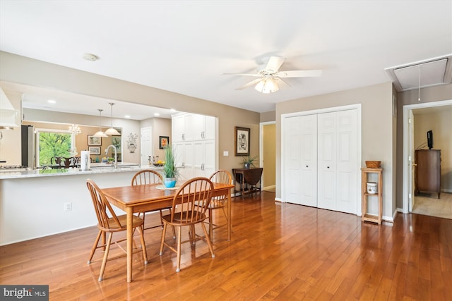 dining room featuring a ceiling fan, attic access, recessed lighting, and wood finished floors