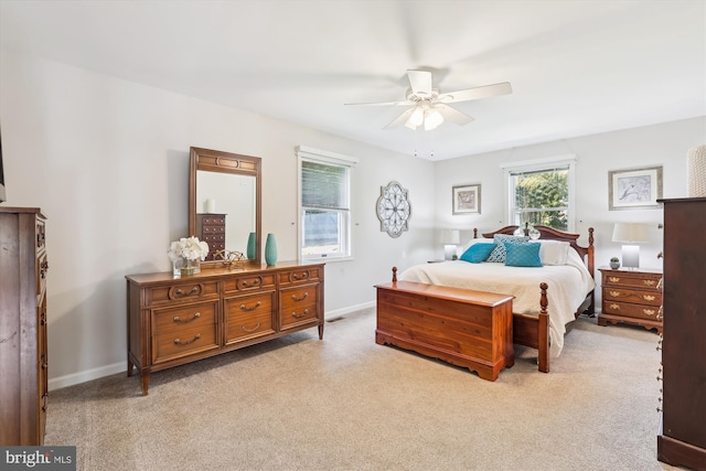 bedroom with baseboards and light carpet