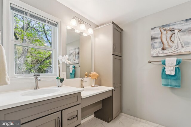 full bathroom featuring double vanity, a sink, and marble finish floor