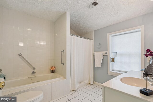full bath featuring a textured ceiling, visible vents, tile patterned floors, vanity, and toilet